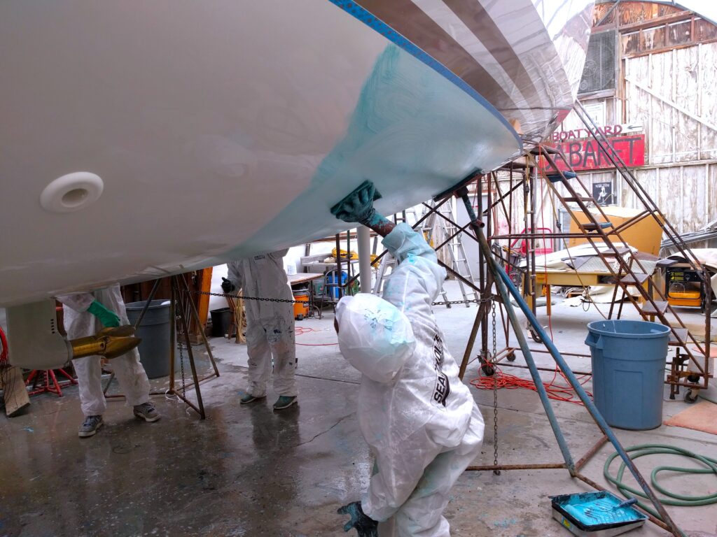 Worker Bottom Prepping Boat